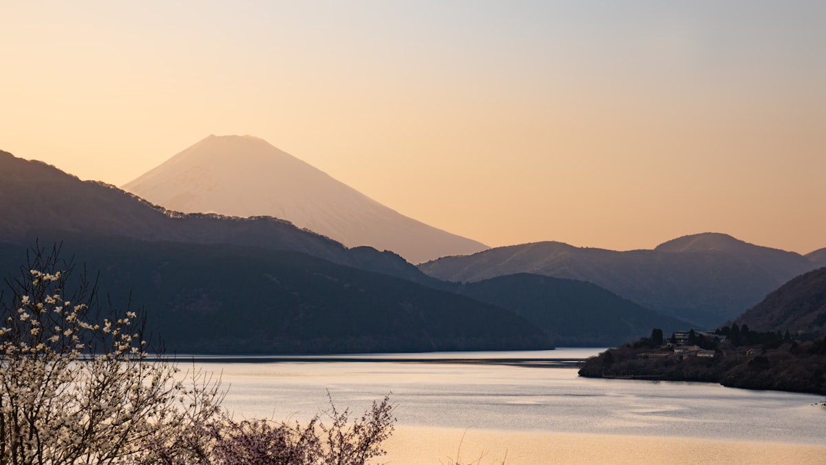 Snow-capped Mount Fuji rising over Lake Ashi at sunrise from Onshi-Hakone Park