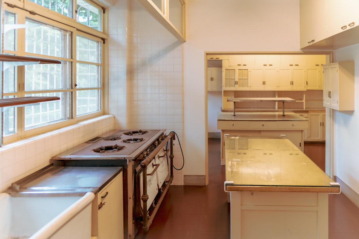 A modern Japanese apartment kitchen with a stovetop and natural light from a window