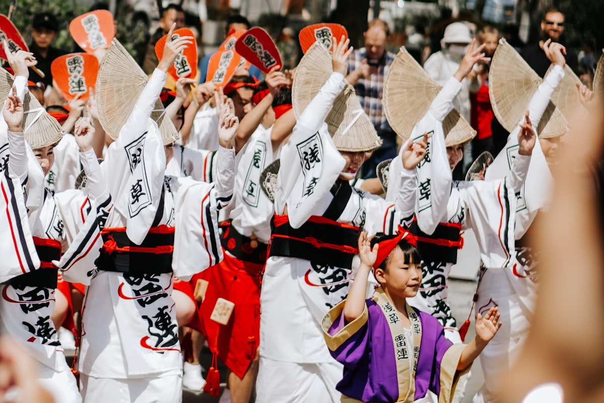Performers in colorful traditional dress dancing at a Japanese summer matsuri