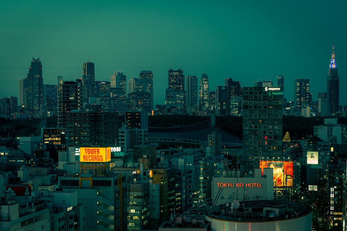Tokyo skyline view at night from a Shinjuku skyscraper, with city lights stretching to the horizon