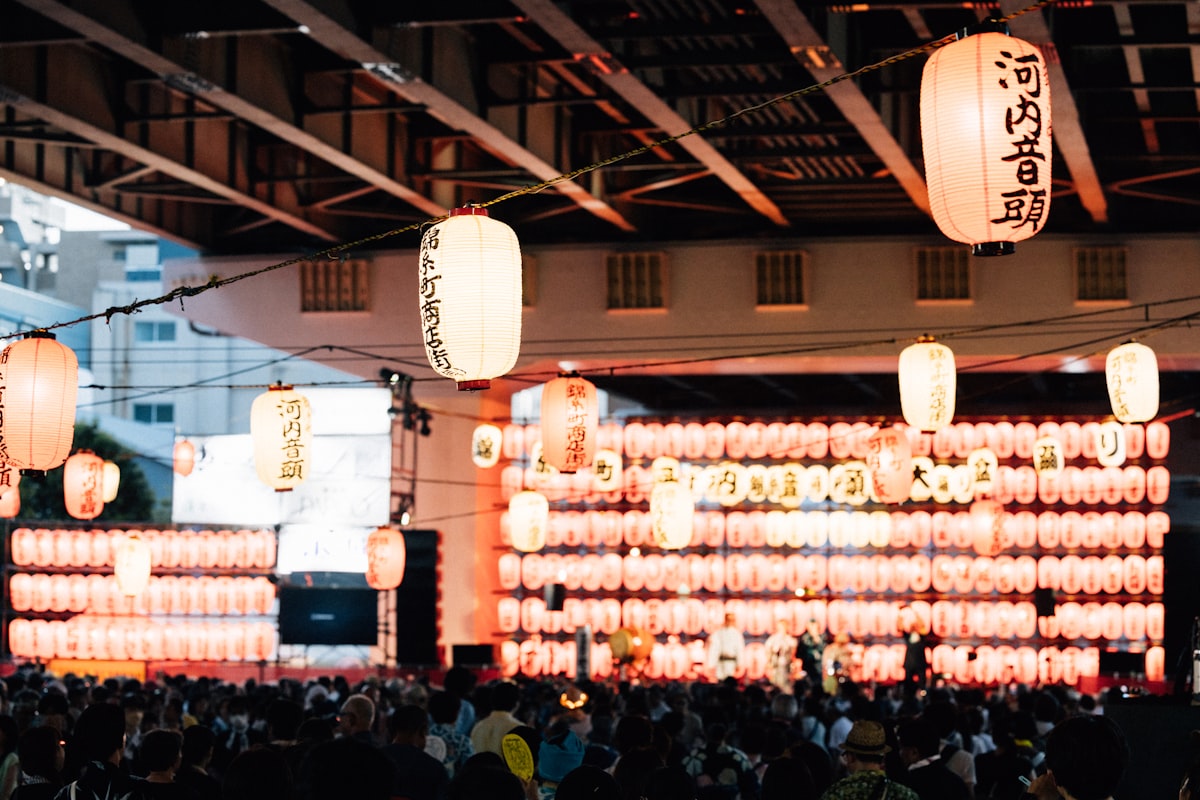 Many illuminated paper lanterns at a Japanese summer festival at night