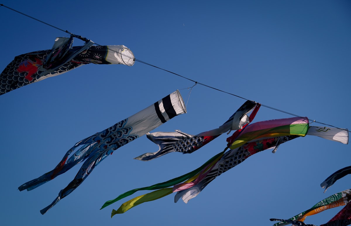 Colorful koinobori carp streamers flying against a clear blue sky
