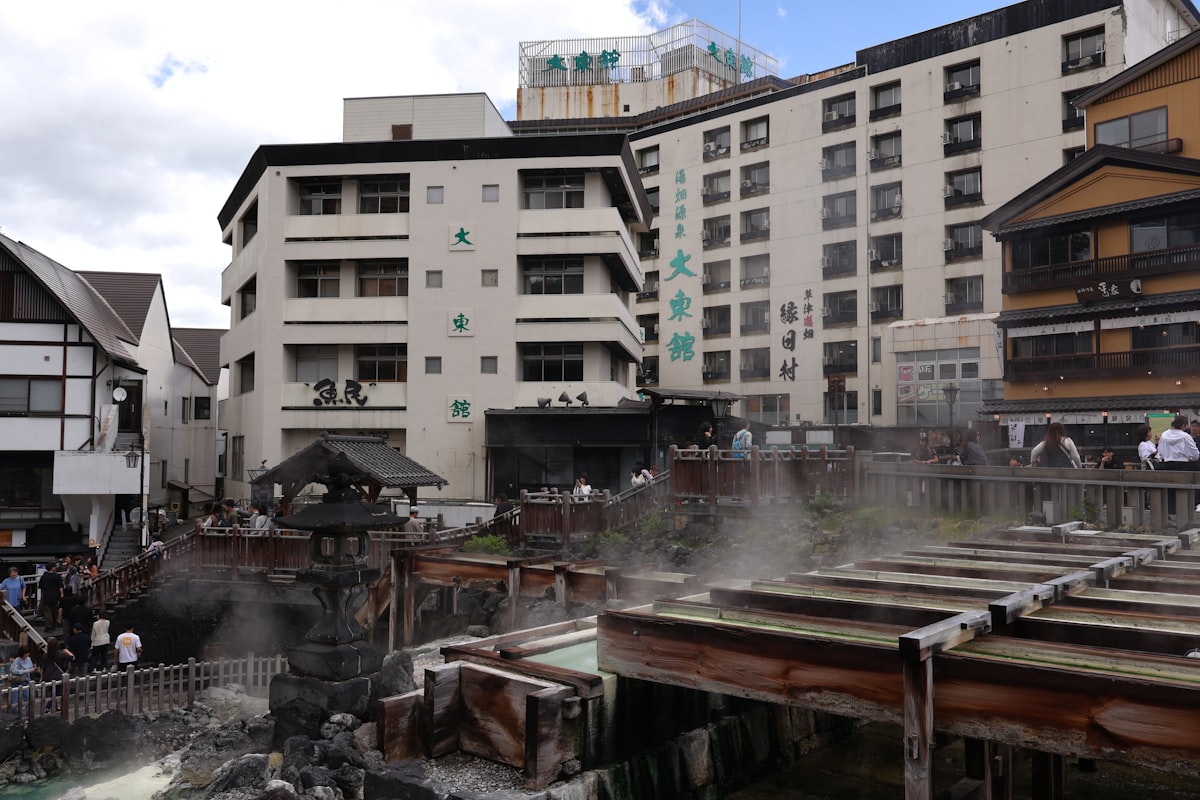 Steam rising from a traditional Japanese hot spring (onsen) in the Kusatsu mountain town