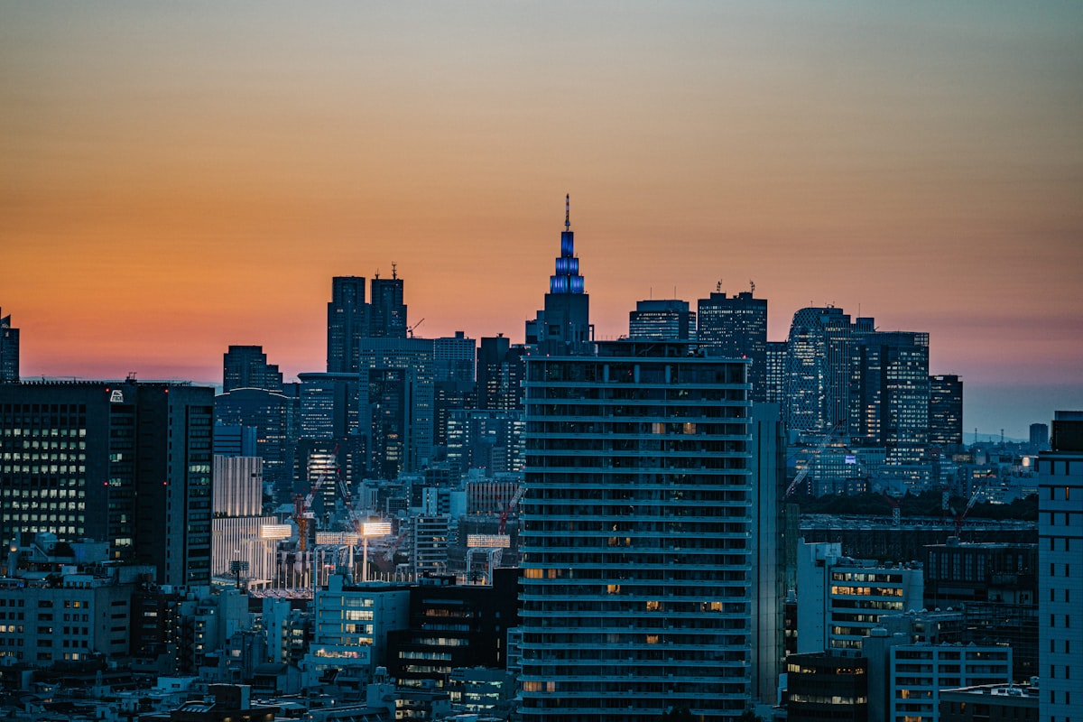 Tokyo skyline at golden hour with skyscrapers silhouetted against the setting sun