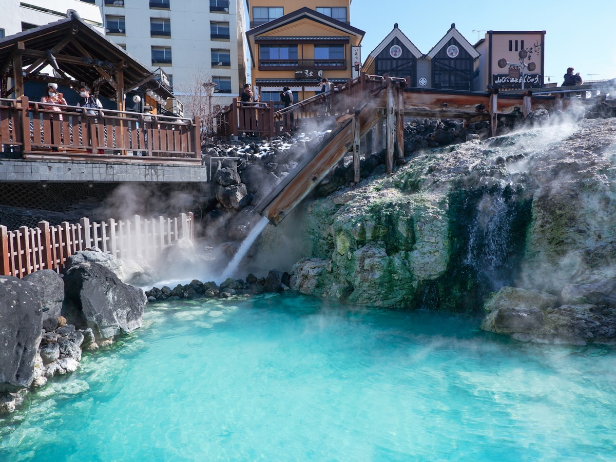 A traditional outdoor onsen at Kusatsu Onsen in Gunma, Japan, with steam rising