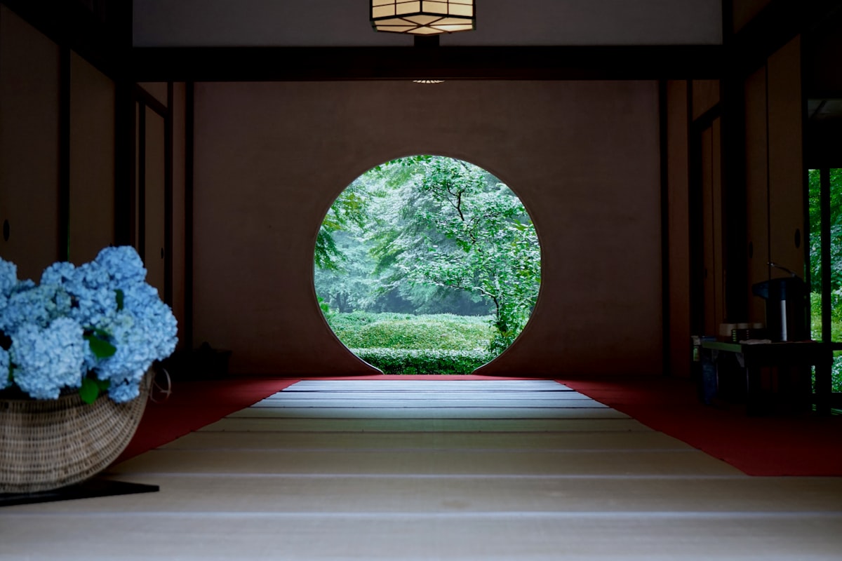 A circular window in a tatami room at Hasedera Temple in Kamakura overlooking the temple gardens