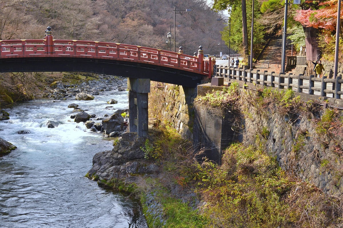 The red Shinkyo Bridge over the rocky Daiya River in Nikko