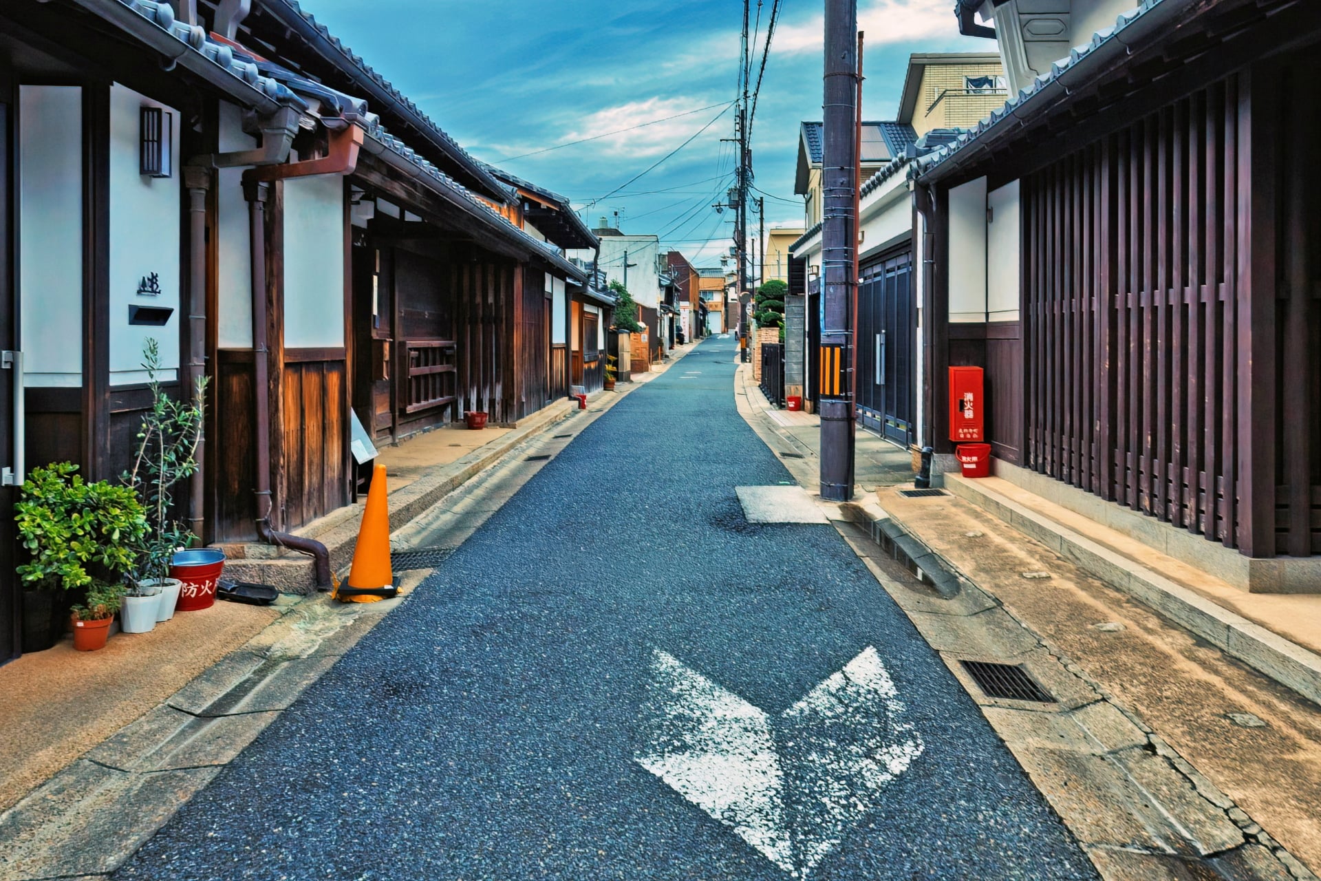 A quiet street lined with wooden townhouses in Naramachi, Nara